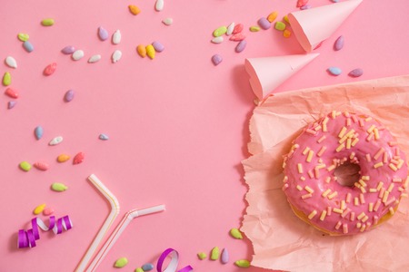 Sprinkled Pink Donut. Frosted sprinkled donut on pink background.の写真素材