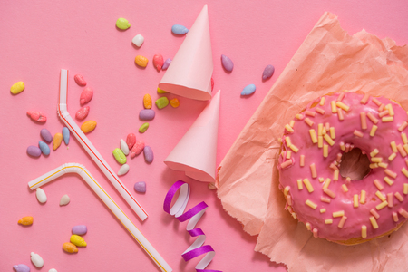 Sprinkled Pink Donut. Frosted sprinkled donut on pink background.の写真素材
