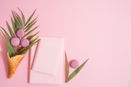 cake macaron, gift or present box and flower on pink table from above. Beautiful breakfast. Flat lay style, copy spaseの写真素材