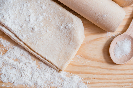 cooking dough, flour and eggs on a wooden table.の写真素材