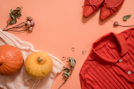 Autumn fall flat lay, top view. Warm knitted sweater, Fall Leaves, chestnuts, rowan berry and...