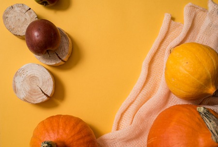 Colorful autumn pattern made of pumpkins,autumn leaves and apples. Knitted orange yellow scarf . Flat lay. Fall concept. Copy spaseの写真素材