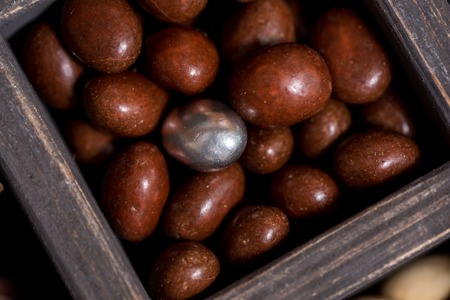 chocolate nuts and one other candy. silver color. New Year's composition. The concept of individuality and leader.の写真素材