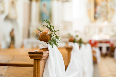 Wedding in the church. bright temple. Shallow depth of field. white ornaments on benches and chairs....