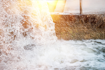 Water droplet bouncing and splash on a sunny summer day.の写真素材