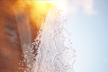 Beautiful mountain rainforest waterfall with fast flowing water and rocks, long exposure. outdoor background with sunの写真素材