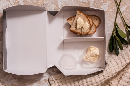 Green school lunch box with sandwich, breakfast. white bread and butter.の写真素材