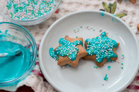 Christmas gingerbread paints are painted with a brush and blue icing sugar.の写真素材