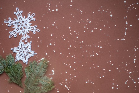 background winter brown, white knitted snowflakes on a dark background.の写真素材