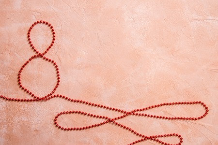 Red gift celebration ribbon in 8 digit shape over whiteの写真素材