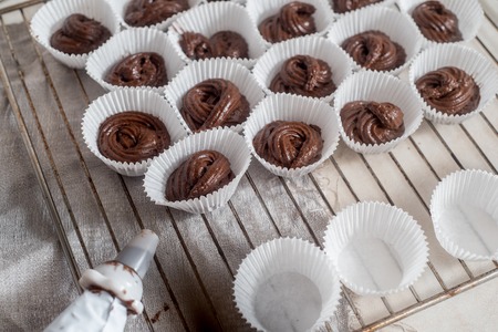 Processes of preparation of chocolate muffins close-up on the table.の写真素材