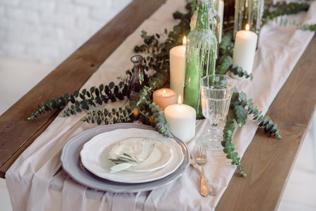 Wedding. Banquet. The chairs and table for guests, decorated with candles, served with cutlery and...