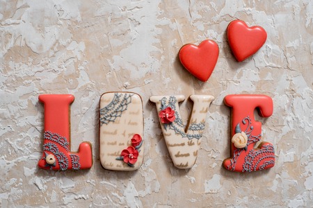 Homemade gingerbread with letters love for Valentines Day located on a dark background, top viewの写真素材