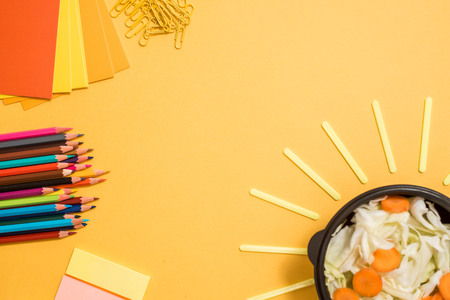 Healthy school lunch for child or teenager. Craft paper package, pile of exercise books, food in lunch box on white wood table. copy spaceの写真素材