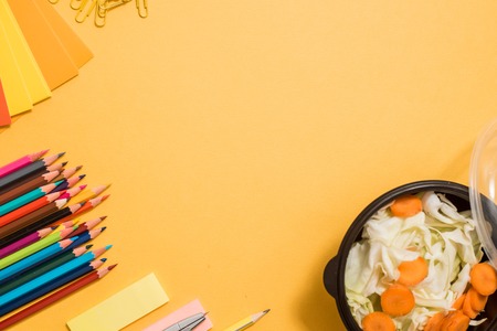 Healthy school lunch for child or teenager. Craft paper package, pile of exercise books, food in lunch box on white wood table. copy spaceの写真素材