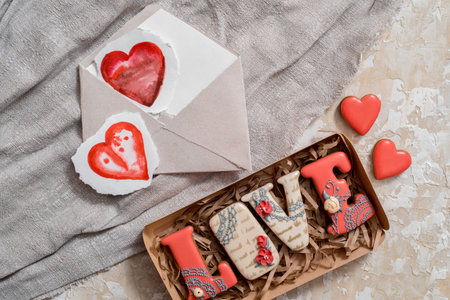 Homemade gingerbread with letters love for Valentine's Day on a background, Red icing, valentine...