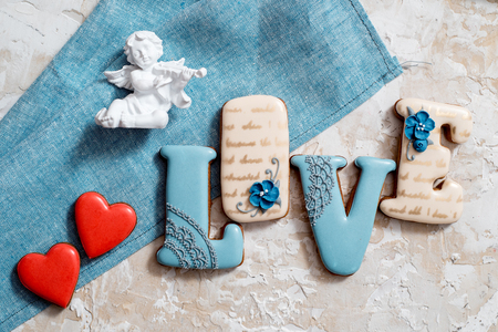 Homemade gingerbread with letters love for Valentine's Day on a background, Red icing, valentine hearts, top view. copy space.の写真素材