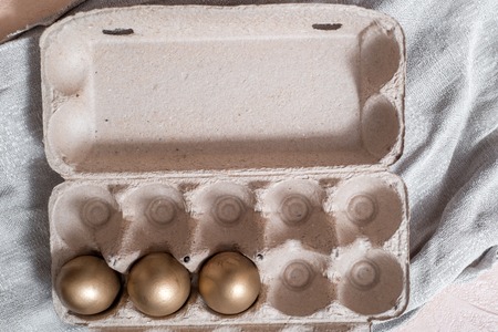 golden eggs on a gray linen napkin. concept of wealth. easter concept.の写真素材