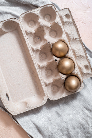 golden eggs on a gray linen napkin. concept of wealth. easter concept.の写真素材