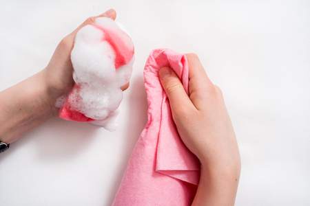 Womens hands wearing pink latex gloves for cleaningの写真素材