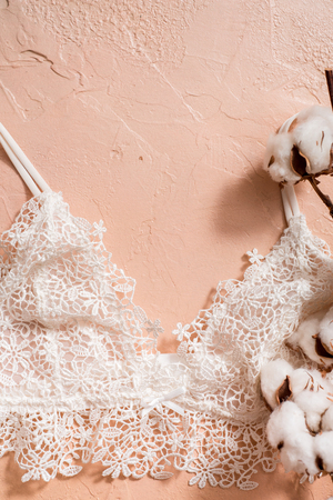 Cotton striped panties and white bra. Womens lingerie on the concrete background. Top view shot of fashionable womens underwear. Natural soft fabricの写真素材