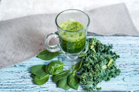 Green smoothie. Apple spinach vegetable smoothie with ingredients on white stone table.の写真素材