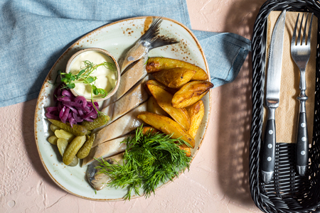 herring salad. herring with homemade baked potatoes, pickled pickled cucumber. Fresh greens and lettuce. Belarusian national dishの写真素材