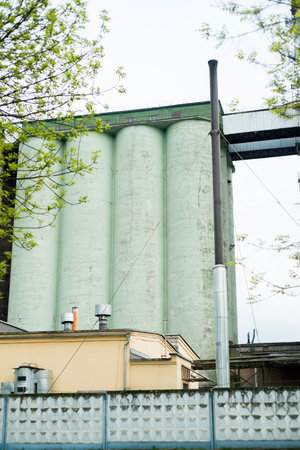 Flour mill. Concrete storage of flour and grain. Bakery yellow and green