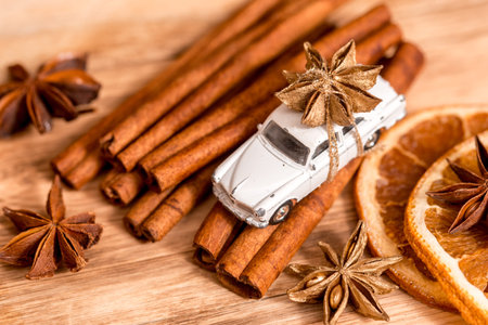 Christmas card with toy car . Cozy christmas with gingerbread cookies, cinnamon, cardamom lemon and...