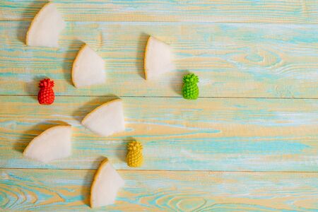 Sliced melon on blue and yellow wooden old background. Summer exotic fruits.Flat lay, top view.の写真素材