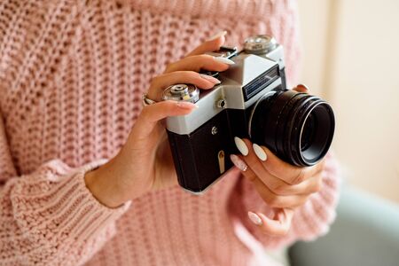 Young woman holding an old vintage camera.の写真素材