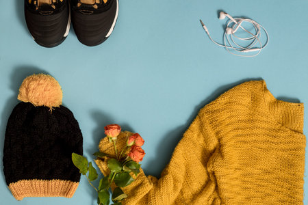 Knitted yellow sweater, flowers, cozy autumn on a blueの写真素材