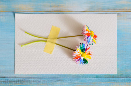 Multi-colored drawing by paints. rainbow flower, multi-colored daisy. on a blue background.bright...