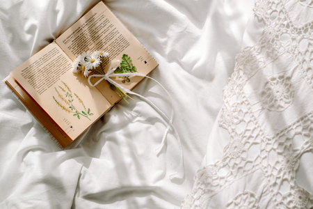 Openwork lace, cotton white blanket. book botany, mug with natural herbal tea made from mint, summer...