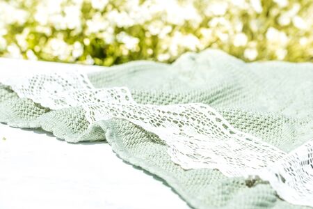 background of a light tablecloth, with White flowers in the garden. festive table setting. table setting details.Blurred bokeh background of greenery and floral design. Morning in the villageの写真素材