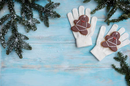 Christmas gingerbread on a white mitten. on a blue wooden background. New Year cardの写真素材