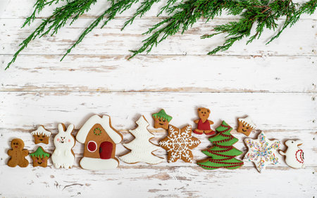 Christmas and Winter Gingerbread Cookies with white glaze on an old wooden background.
