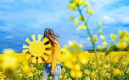 freedom, blue sky, yellow field, jumping teenager girl on sky background. blue and yellow balloons....