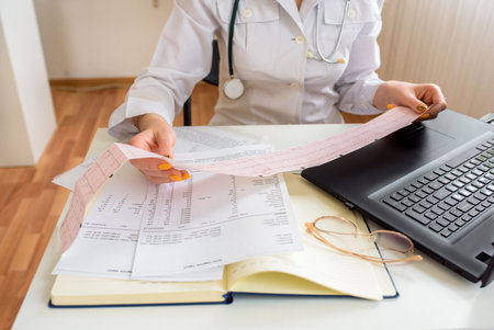 Online consultation.female doctor work with computer and pape note in order medical care to nurse for good health of patient.clinic hospital for health care.の写真素材