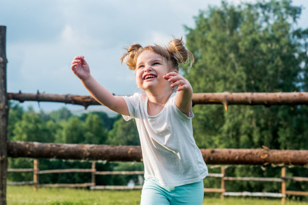 Sweet child child trying to catch soap bubble.Summer in the village. Warm sunset. Happy childhood.Laughter joy and fun.の写真素材