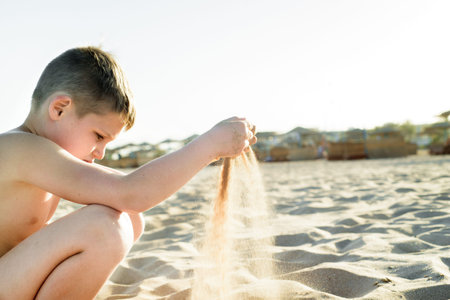 Sand castle made of sand by the hands of a child on the shore.Sea at sunset, white sand on the beach.の写真素材