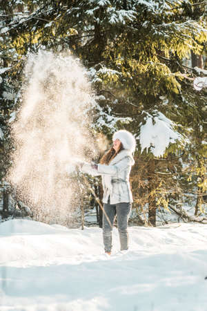 Portrait of young woman in the frosty winter forestの写真素材