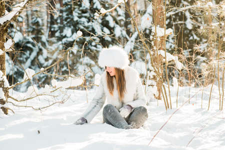 Portrait of young woman in the frosty winter forestの写真素材