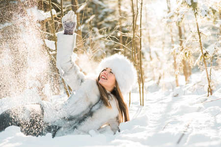 Portrait of young woman in the frosty winter forestの写真素材
