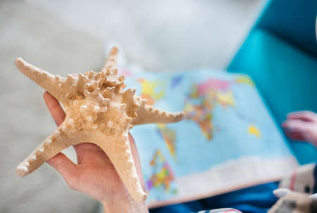 Travel concept. Young boy dreams of traveling as he using globe.の写真素材