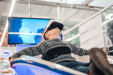 Boy in virtual reality glasses playing the game