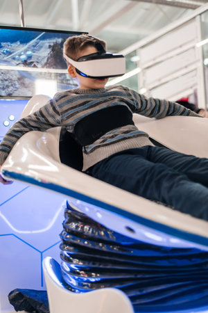 Boy in virtual reality glasses playing the game