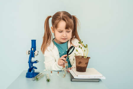education concept. Little baby Girl look at the microscopes in the laboratory.の写真素材