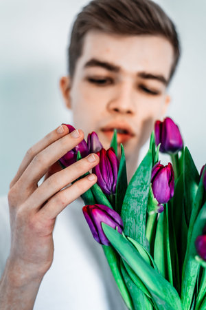 Tender tulips for her. Man, guy with tulips bouquetの写真素材