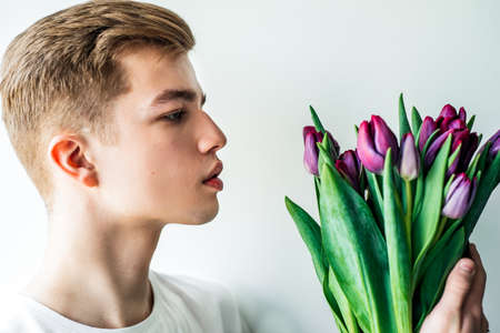 Tender tulips for her. Man, guy with tulips bouquetの写真素材